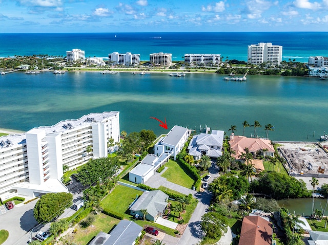 drone / aerial view featuring a view of city and a water view