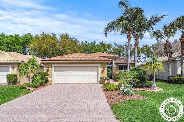 view of front facade with decorative driveway, a tiled roof, an attached garage, and stucco siding