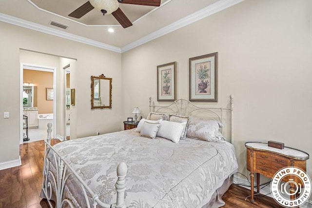 bedroom featuring hardwood / wood-style floors, baseboards, visible vents, ceiling fan, and ornamental molding