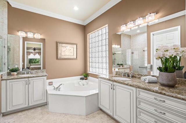 bathroom with a shower stall, vanity, and a garden tub