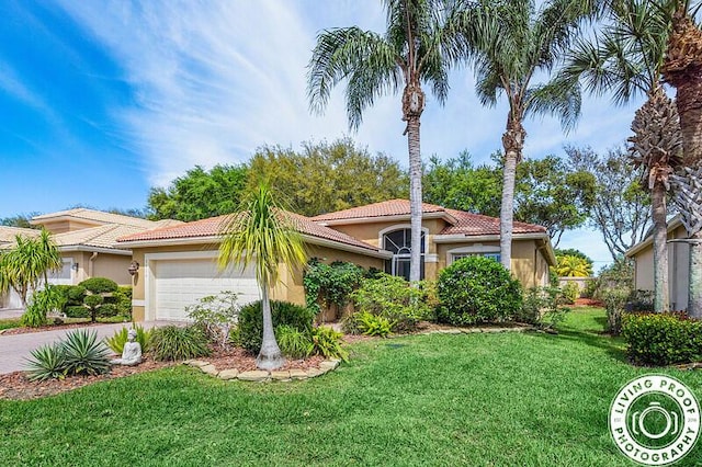 view of front of house with a front yard, driveway, stucco siding, a garage, and a tiled roof