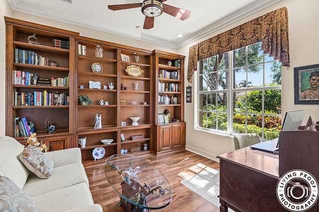 sitting room with ceiling fan, ornamental molding, and light wood finished floors