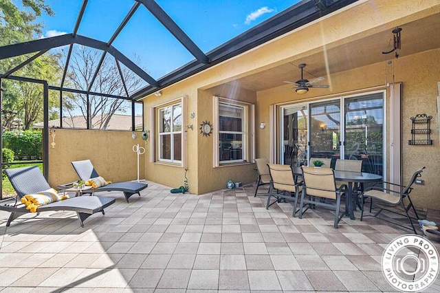 view of patio / terrace featuring a lanai and ceiling fan