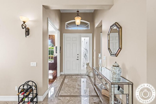 foyer entrance featuring baseboards and marble finish floor