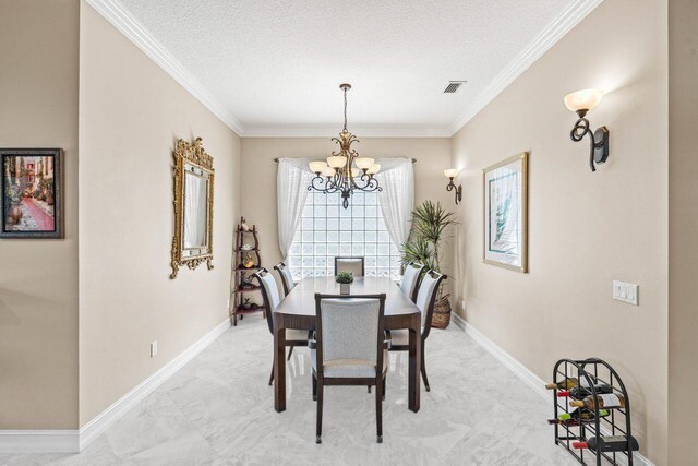 dining room featuring a notable chandelier, baseboards, visible vents, and ornamental molding