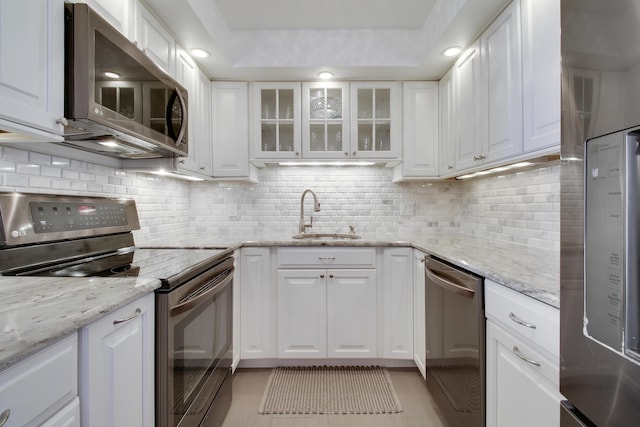 kitchen featuring a sink, white cabinetry, and stainless steel appliances