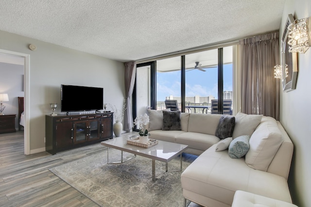 336 Golfview Rd Unit 807, North Palm Beach, FL 33408 - living area with a textured ceiling, floor to ceiling windows, baseboards, and light wood-style flooring