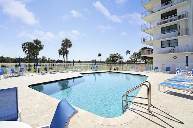 community pool featuring a patio area and fence