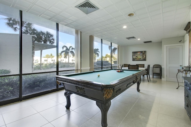 game room featuring floor to ceiling windows, light tile patterned flooring, recessed lighting, and visible vents