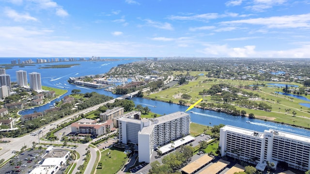 drone / aerial view with a city view and a water view