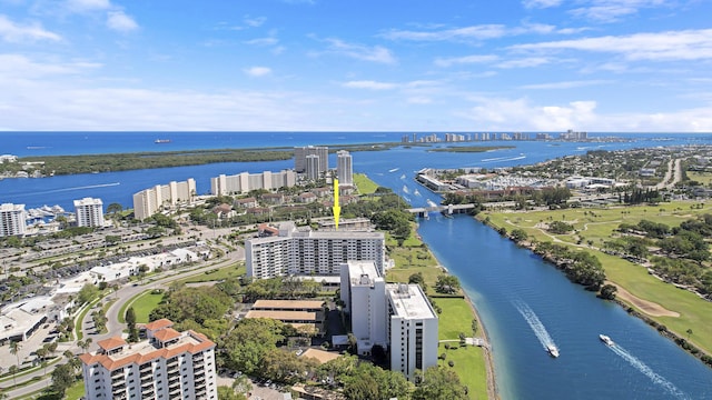 drone / aerial view featuring a view of city and a water view