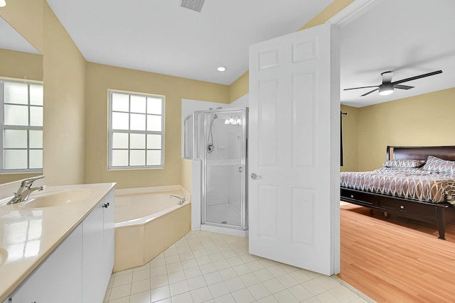 bathroom featuring a garden tub, connected bathroom, a shower stall, and vanity