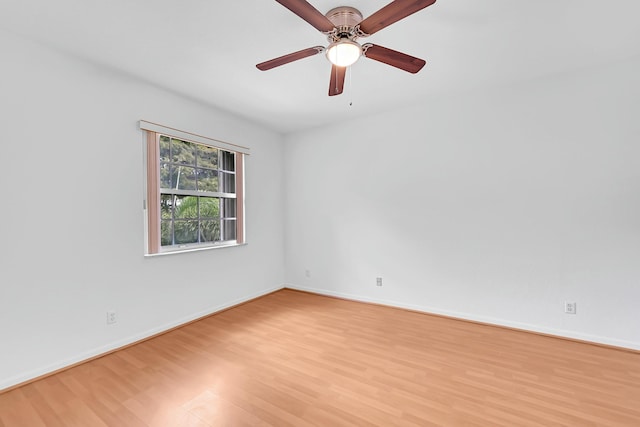 empty room with baseboards, ceiling fan, and light wood-style floors