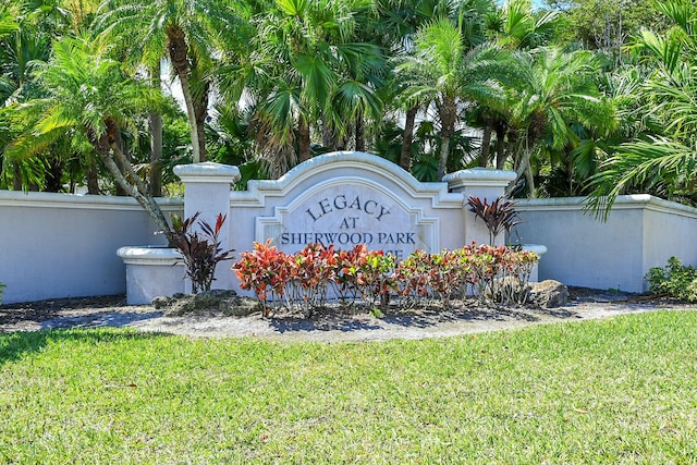 community / neighborhood sign with a lawn