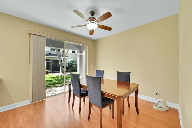 dining room with a ceiling fan, light wood-type flooring, and baseboards