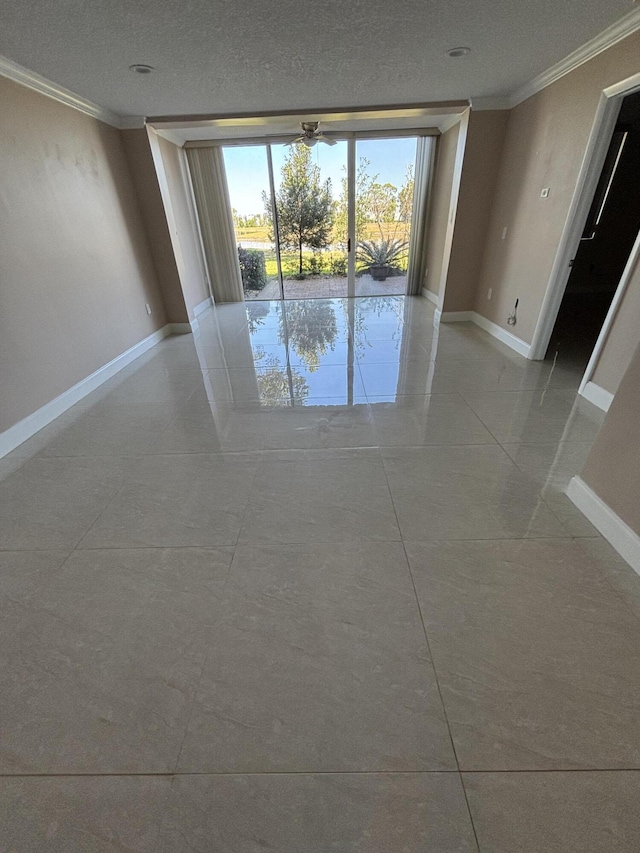 4822 Esedra Ct Unit 101, Lake Worth, FL 33467 - empty room featuring crown molding, baseboards, and a textured ceiling
