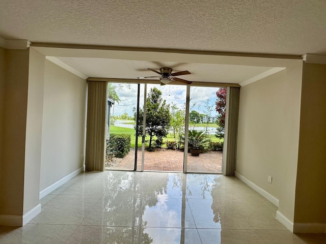 4822 Esedra Ct Unit 101, Lake Worth, FL 33467 - empty room featuring floor to ceiling windows, baseboards, a ceiling fan, crown molding, and a textured ceiling