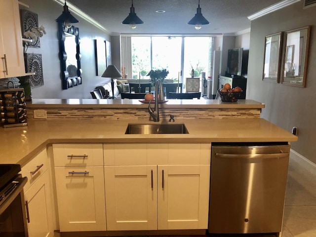 kitchen featuring white cabinets, light countertops, crown molding, stainless steel dishwasher, and a sink