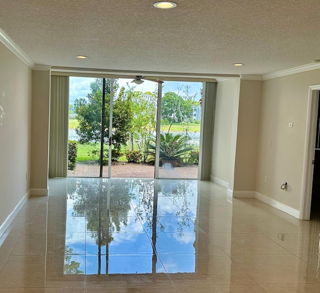 4822 Esedra Ct Unit 101, Lake Worth, FL 33467 - spare room with baseboards, crown molding, plenty of natural light, a textured ceiling, and expansive windows