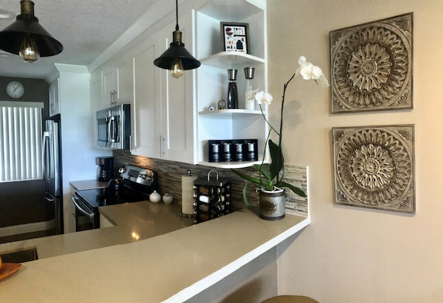 kitchen featuring tasteful backsplash, appliances with stainless steel finishes, decorative light fixtures, white cabinetry, and open shelves