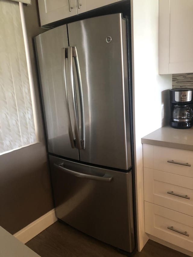 4822 Esedra Ct Unit 101, Lake Worth, FL 33467 - kitchen view of freestanding refrigerator, white cabinets, light countertops, and dark wood-style flooring