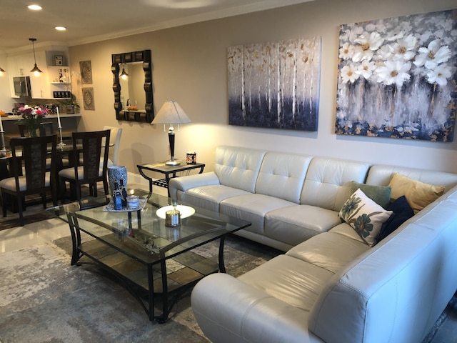 living area with ornamental molding and recessed lighting