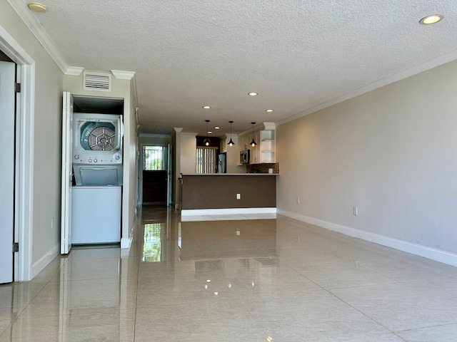 4822 Esedra Ct Unit 101, Lake Worth, FL 33467 - unfurnished living room featuring ornamental molding, estacked washer and dryer, a textured ceiling, baseboards, and recessed lighting