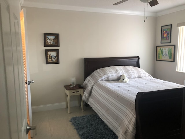 tiled bedroom with a ceiling fan, baseboards, and crown molding