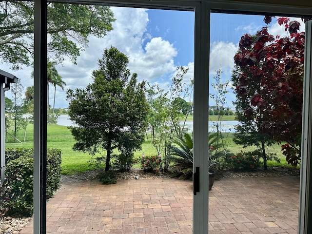 4822 Esedra Ct Unit 101, Lake Worth, FL 33467 - doorway to outside featuring a water view and brick flooring