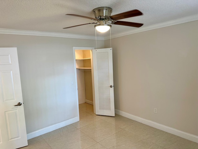 4822 Esedra Ct Unit 101, Lake Worth, FL 33467 - unfurnished bedroom with crown molding, baseboards, a spacious closet, a textured ceiling, and light tile patterned flooring