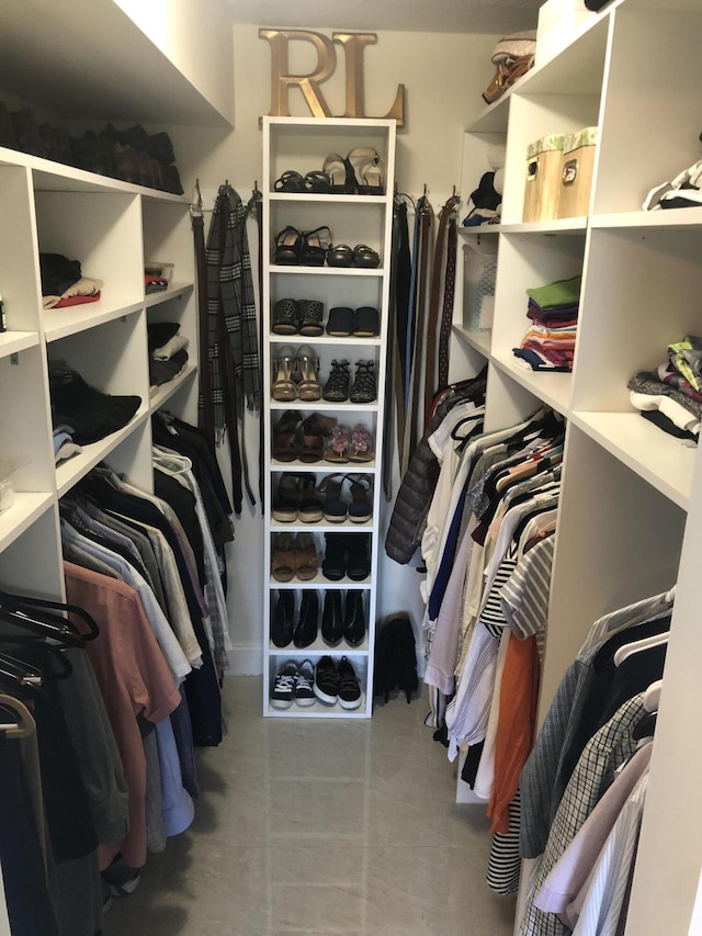 walk in closet with tile patterned floors