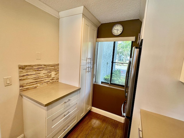 4822 Esedra Ct Unit 101, Lake Worth, FL 33467 - doorway to outside featuring dark wood-style flooring, a textured ceiling, and baseboards