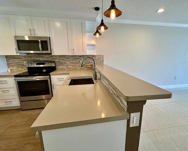 4822 Esedra Ct Unit 101, Lake Worth, FL 33467 - kitchen featuring stainless steel appliances, a sink, decorative backsplash, white cabinetry, and a textured ceiling