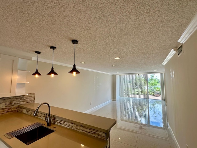4822 Esedra Ct Unit 101, Lake Worth, FL 33467 - kitchen featuring crown molding, decorative backsplash, a textured ceiling, open shelves, and a sink