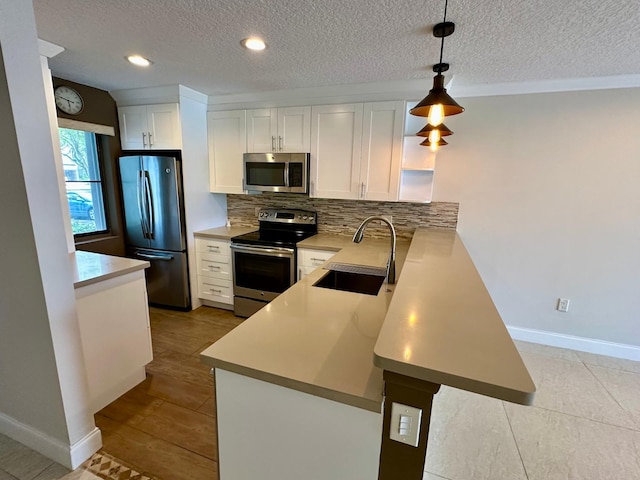 4822 Esedra Ct Unit 101, Lake Worth, FL 33467 - kitchen with stainless steel appliances, a sink, backsplash, a textured ceiling, and white cabinets