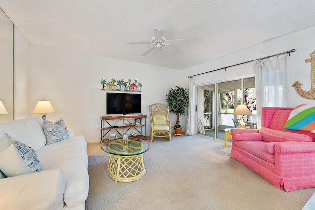 carpeted living room featuring a ceiling fan and a textured ceiling