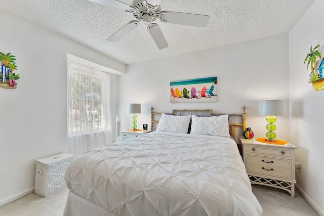 bedroom with a textured ceiling, ceiling fan, carpet flooring, and baseboards