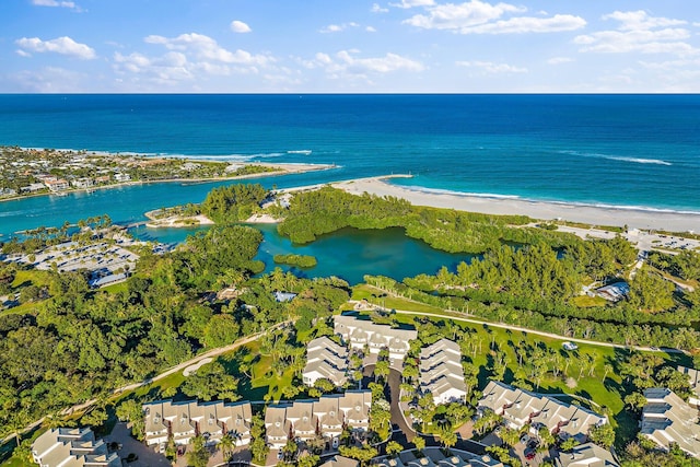 birds eye view of property featuring a water view and a beach view