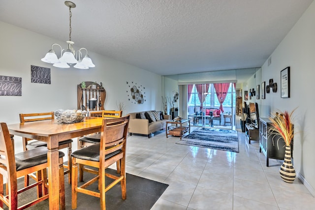 dining room featuring a chandelier, light tile patterned flooring, and a textured ceiling