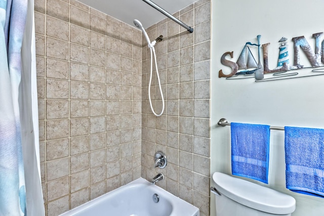 bathroom featuring toilet and shower / bath combo with shower curtain