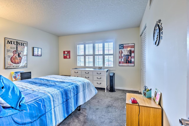 carpeted bedroom featuring a closet, visible vents, a textured ceiling, and baseboards