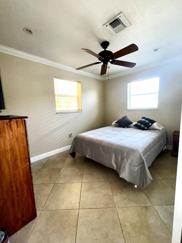 bedroom featuring light tile patterned floors, baseboards, visible vents, ceiling fan, and crown molding