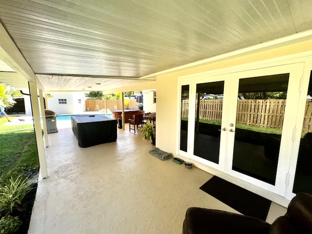 view of patio / terrace featuring french doors and fence