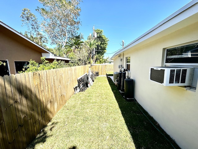 view of yard with cooling unit and fence