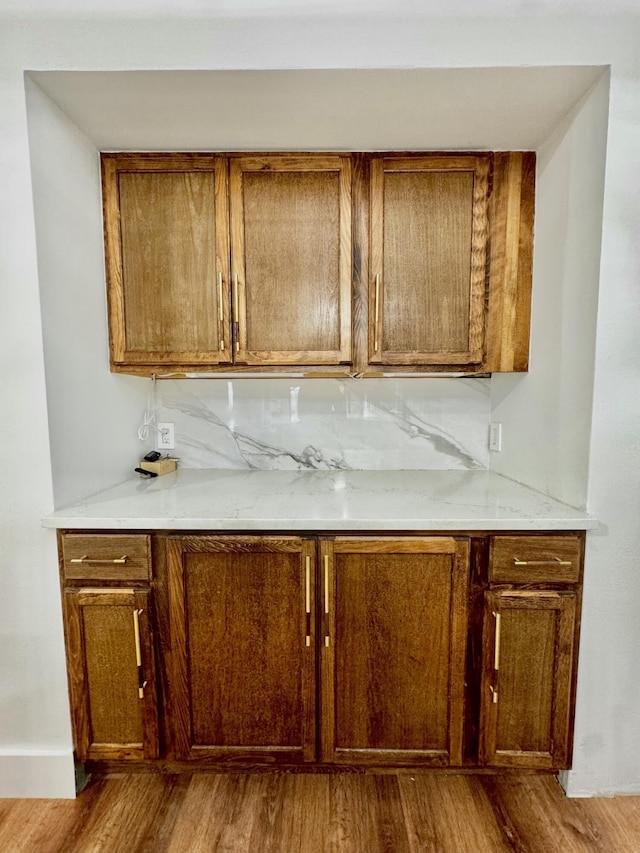 bar featuring tasteful backsplash and wood finished floors