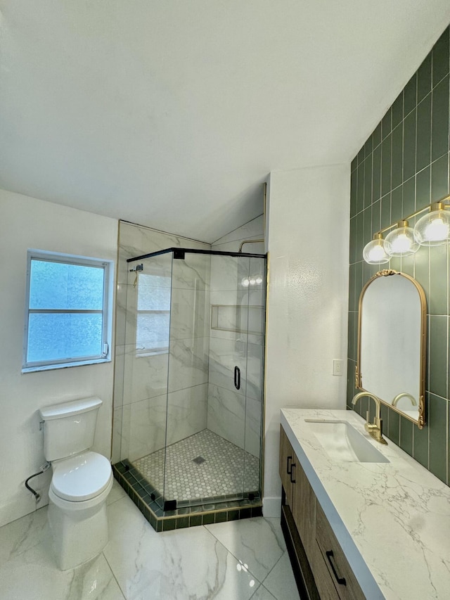 full bath featuring toilet, marble finish floor, a shower stall, and vanity