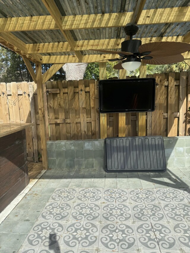 view of patio / terrace featuring ceiling fan and fence