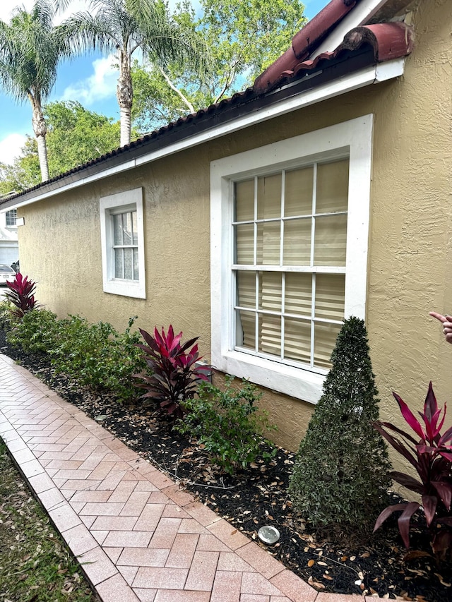 view of side of home featuring stucco siding