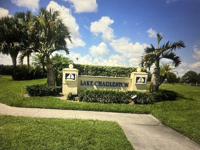 community / neighborhood sign with a yard