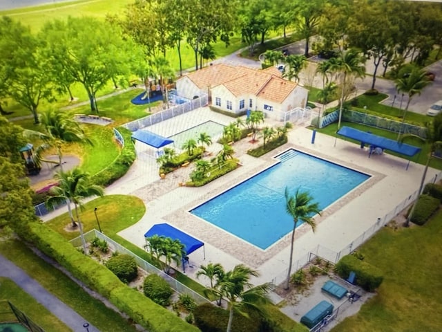 view of pool with fence and a water play area